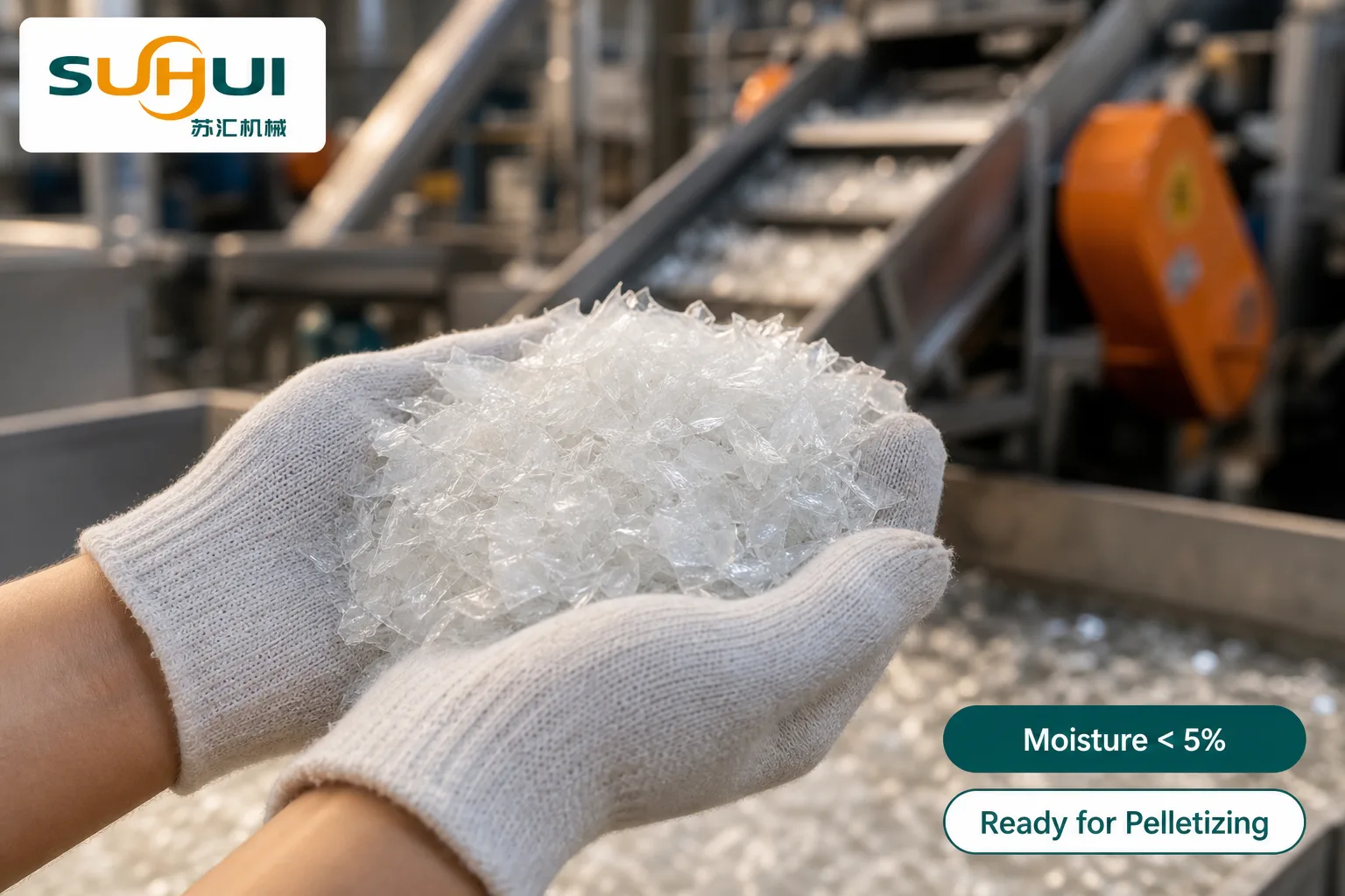 Operator holding clean washed PE film flakes with moisture below 5 percent ready for pelletizing beside the film washing line