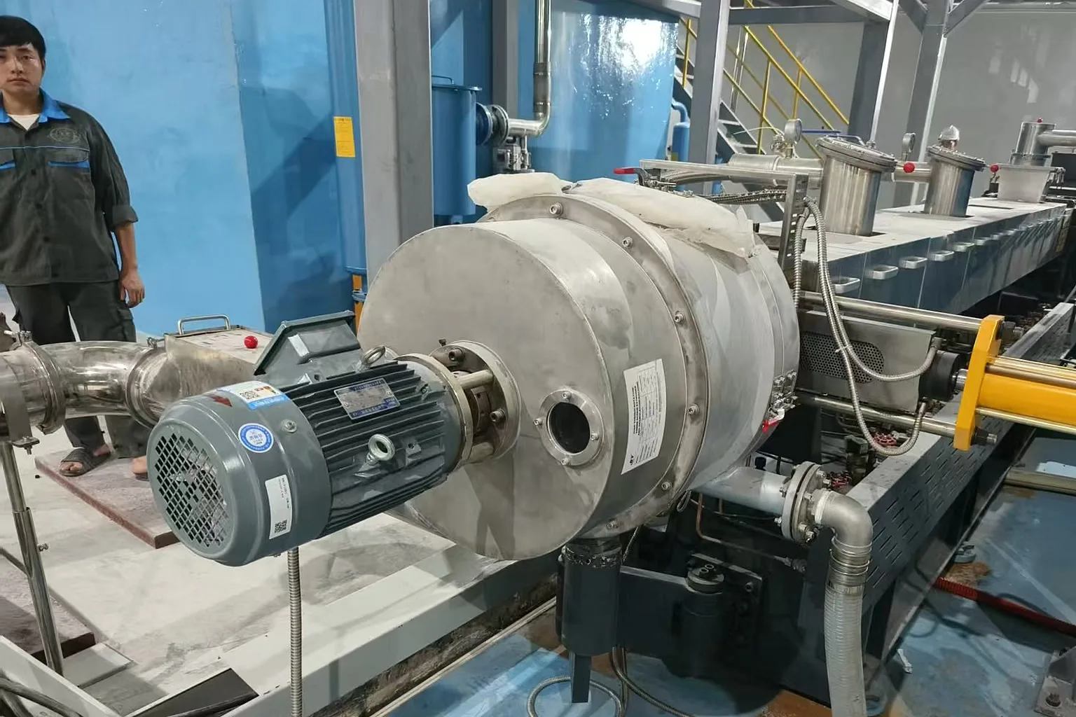 Centrifugal pellet dryer removing surface water from recycled plastic pellets at customer site